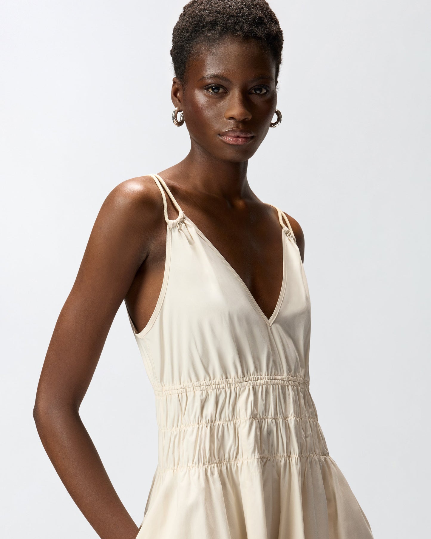 Sleeveless midi dress with pleats and gathering